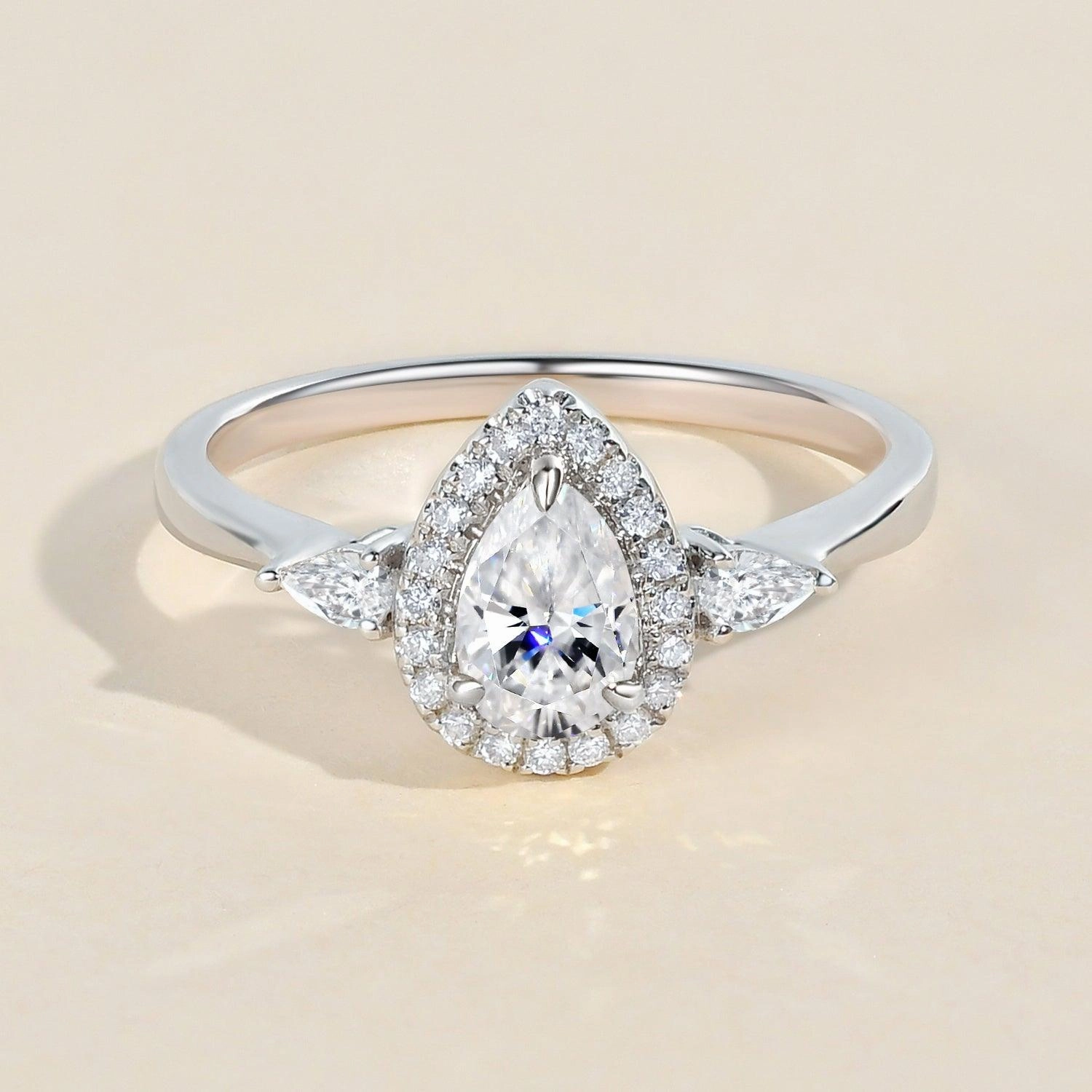 1.0ct Pear Shaped Moissanite Three-Stone Halo Ring Exclusive Accent